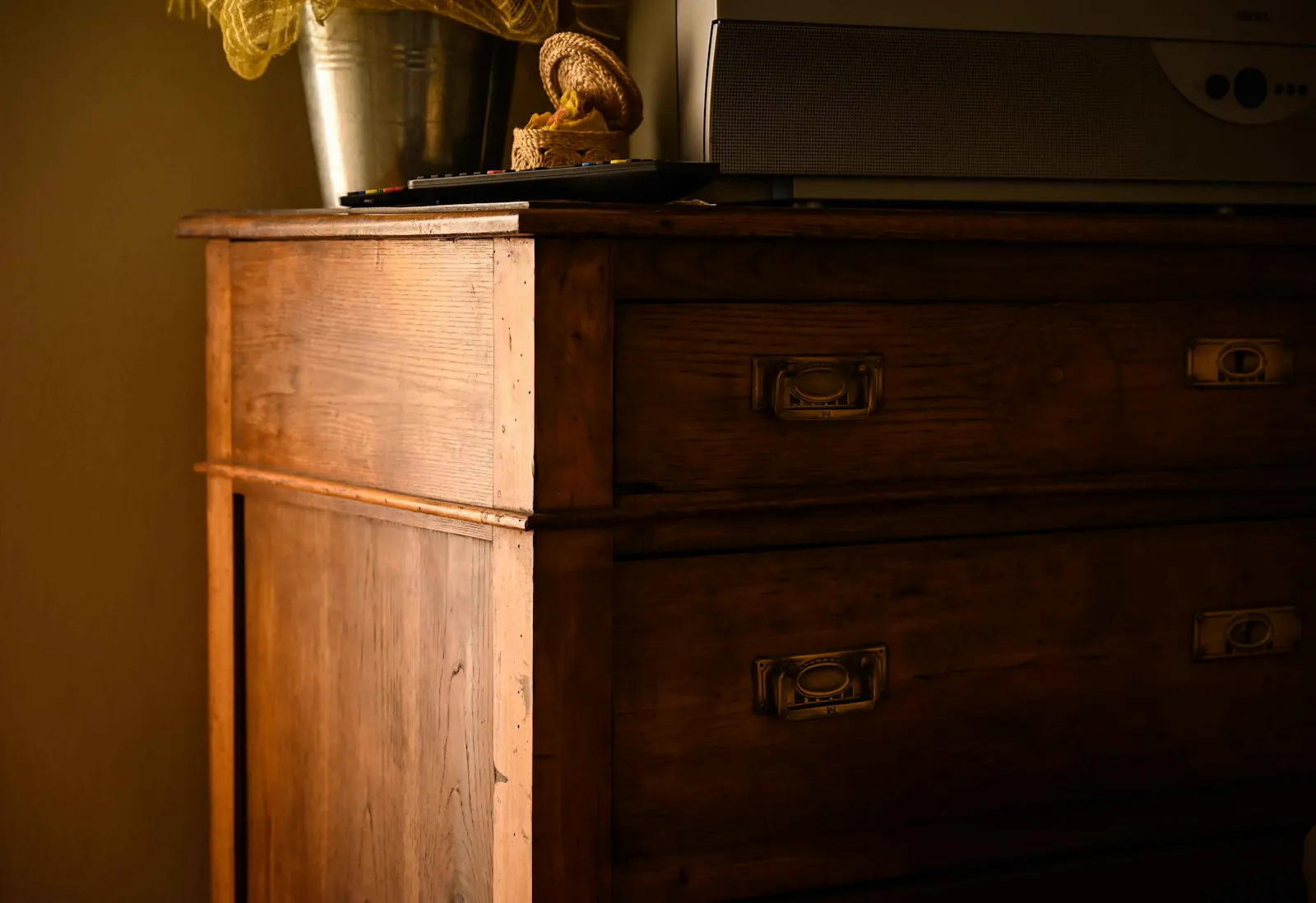 Antique wooden chest of drawers with original recessed brass hardware